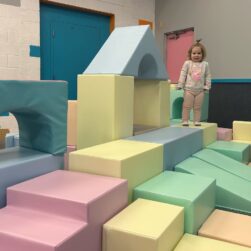 Girl playing on big blocks.