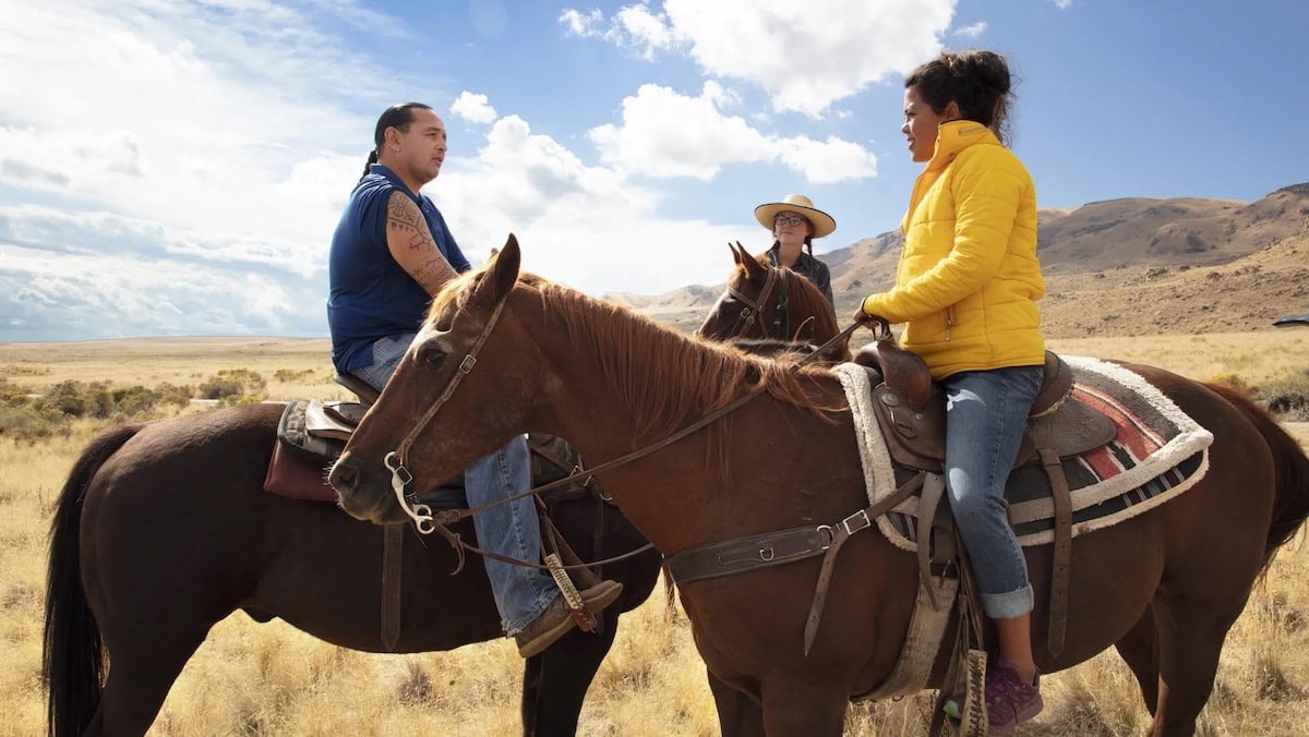 People riding horses in a movie.