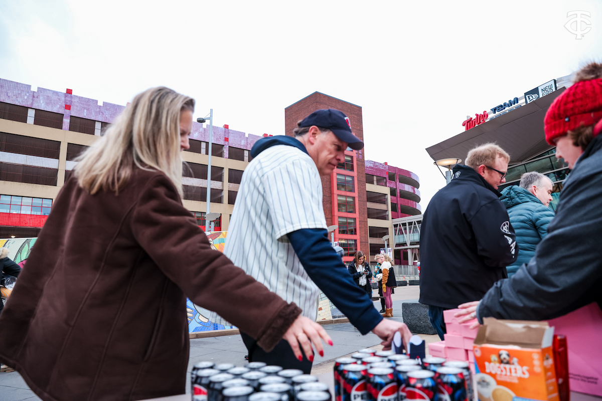 Fans taking food from table at Minnesota Twins Home Opener Breakfast.