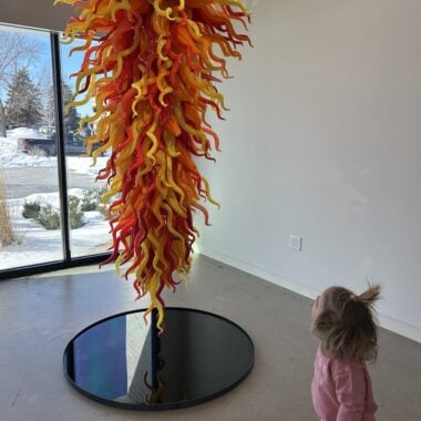 kid with large glass artwork.