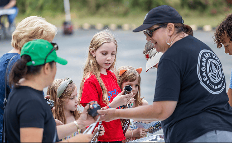 children and adults with art supplies at Eagan Art Block