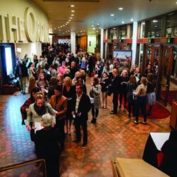 People gathering at the entrance of Thrifty Minnesota thrift store event, showcasing a lively shopping atmosphere and community engagement.