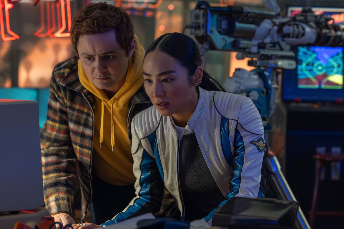 Arturo Castro as Seth Flores and Greta Lee as Eve Kim in Disney's Live Action TRON: ARES.