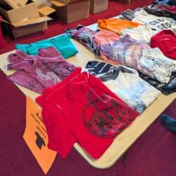 Clothing on a table at a swap event.