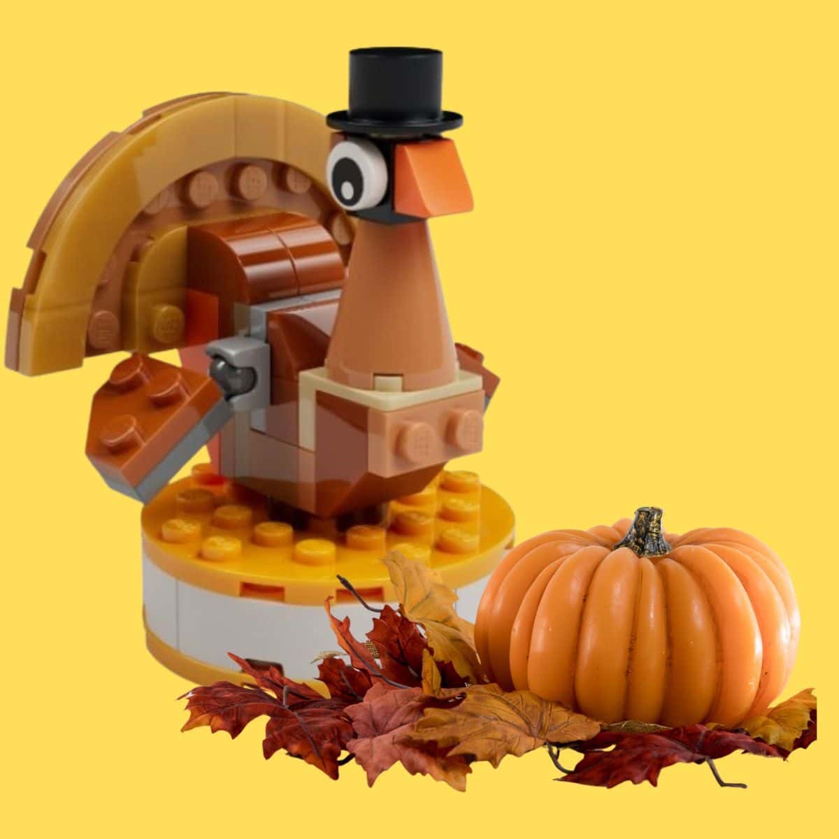 Tom the Turkey lego next to a pumpkin and leaves.
