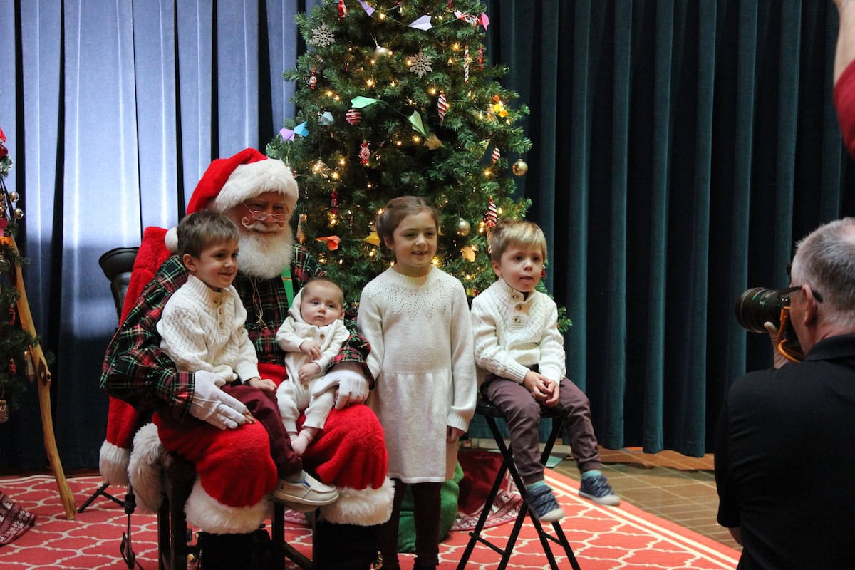 Kids visiting Santa at Landmark Center Santas Workshop in St. Paul.