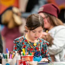 Girl crafting at table at the Walker Art Center.