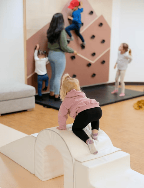 Kids climbing at Nurture to Play Cafe in Sartell MN.
