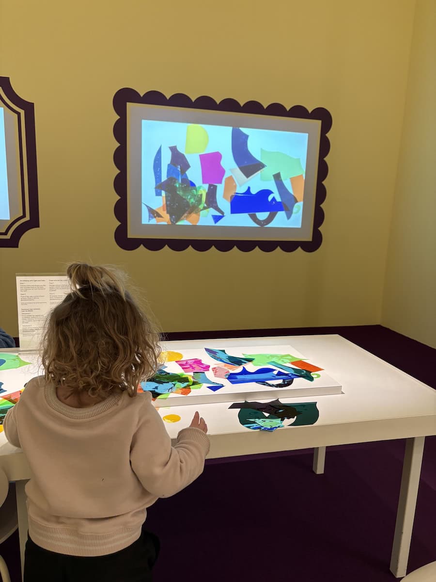 Child making light art at the Walker.