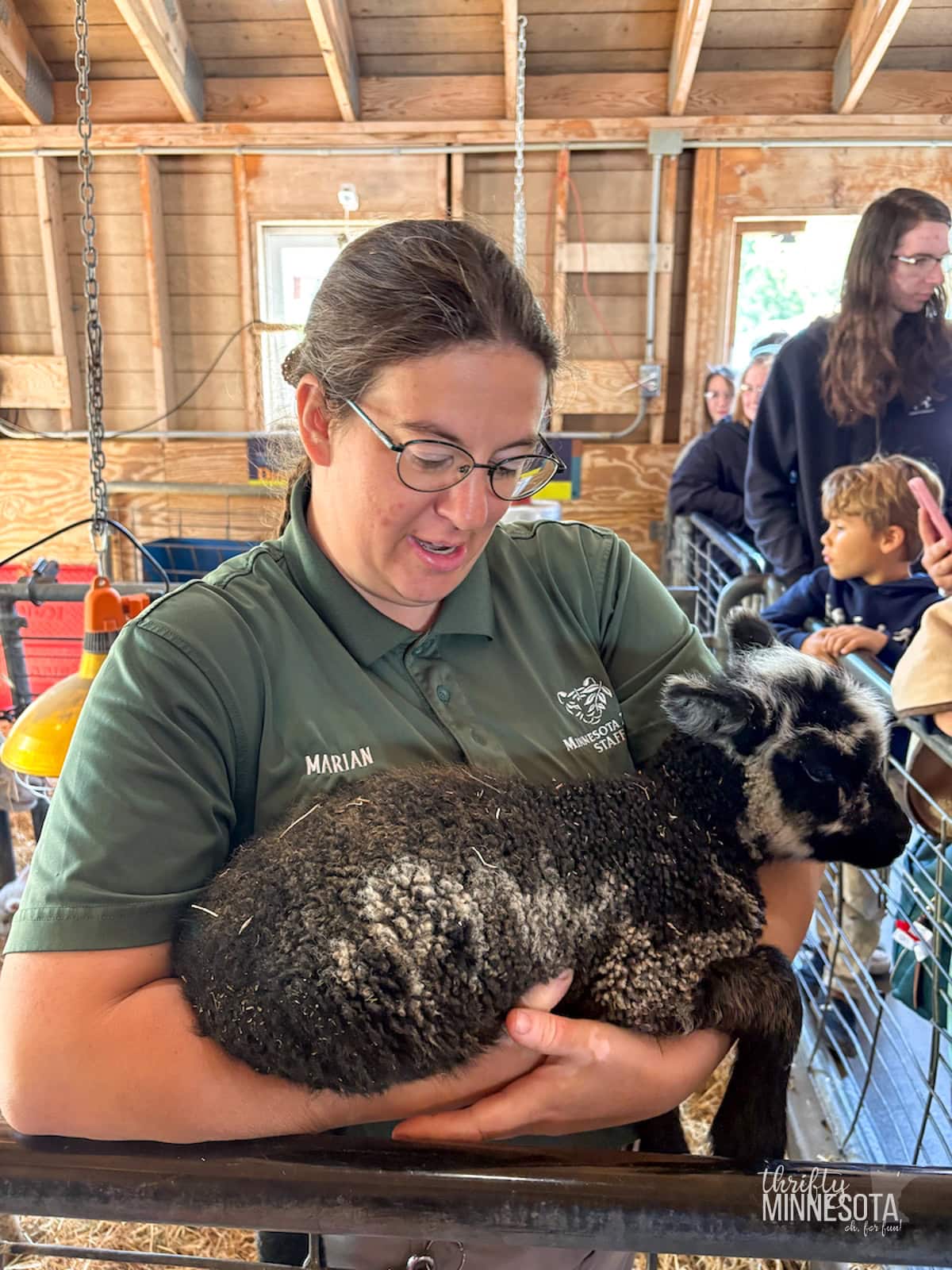 Minnesota Zoo Employee with baby goat.