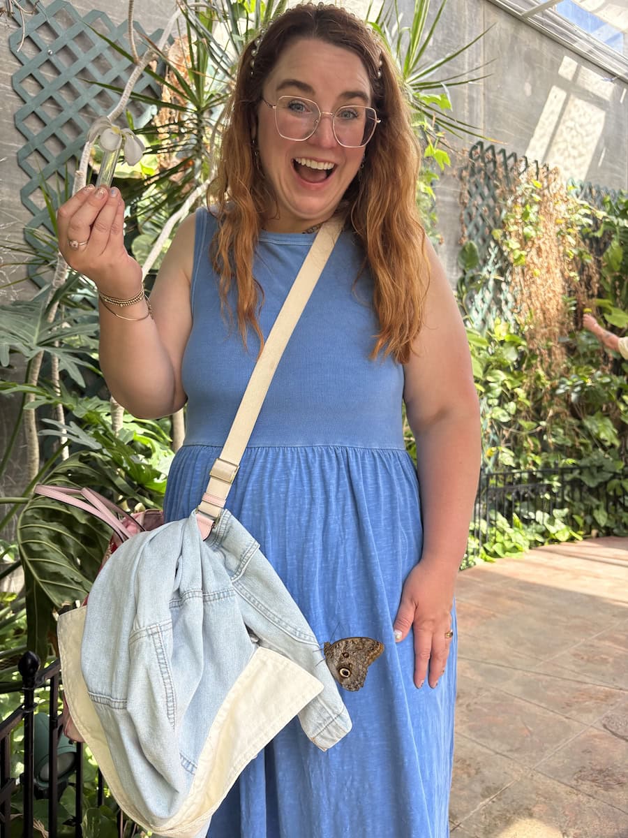 Author with butterfly on her inside Butterfly House and Aquarium.