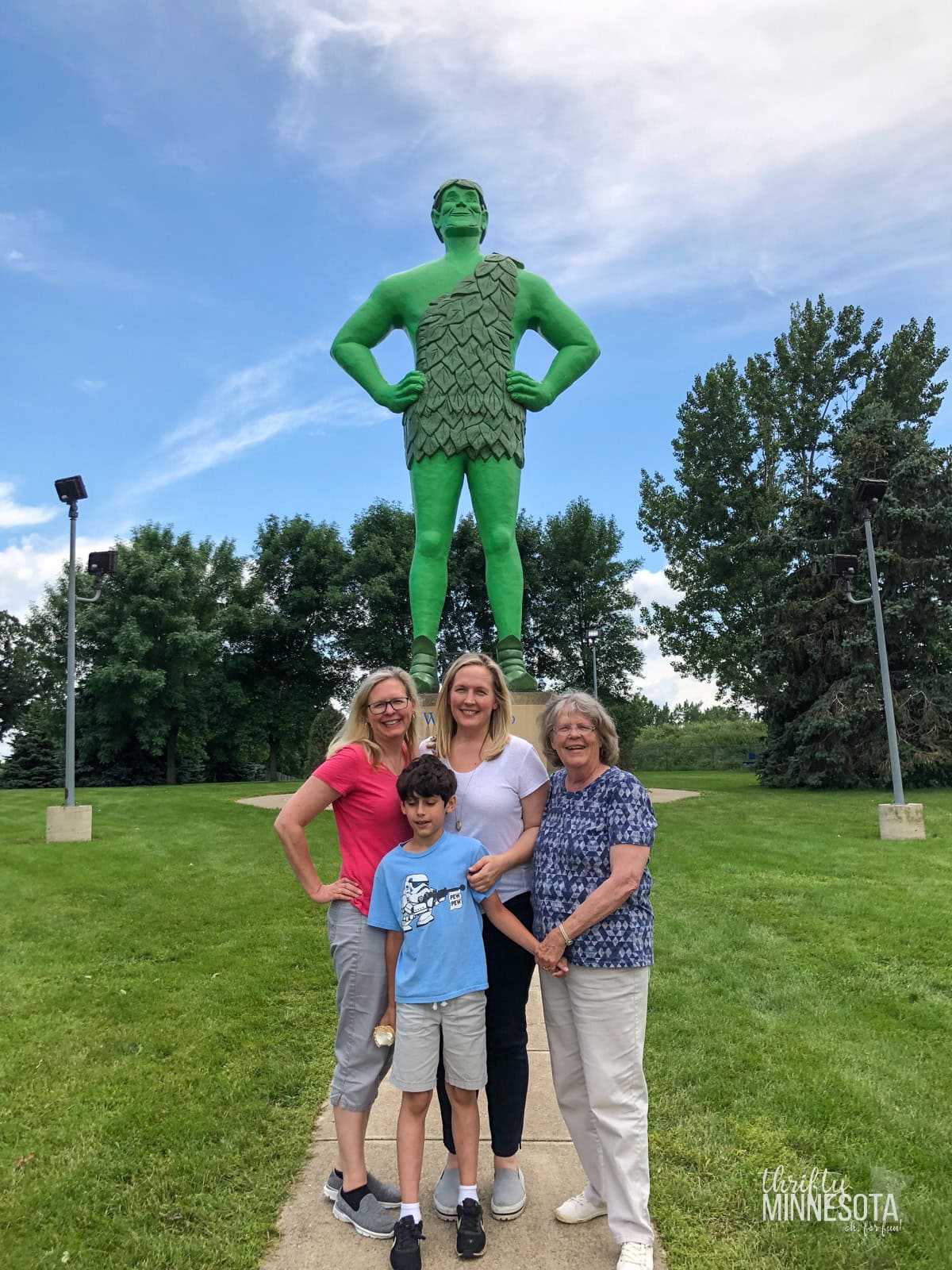 Family posing in front of Jolly Green Giant Statue in Blue Earth Minnesota.