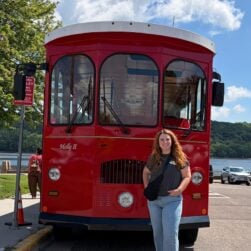 Woman standing in front of trolley.