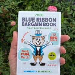 Hand holding 2026 Minnesota State Fair Blue Ribbon Bargain Book.