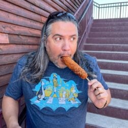 Man eating a Minnesota State Fair corn dog.