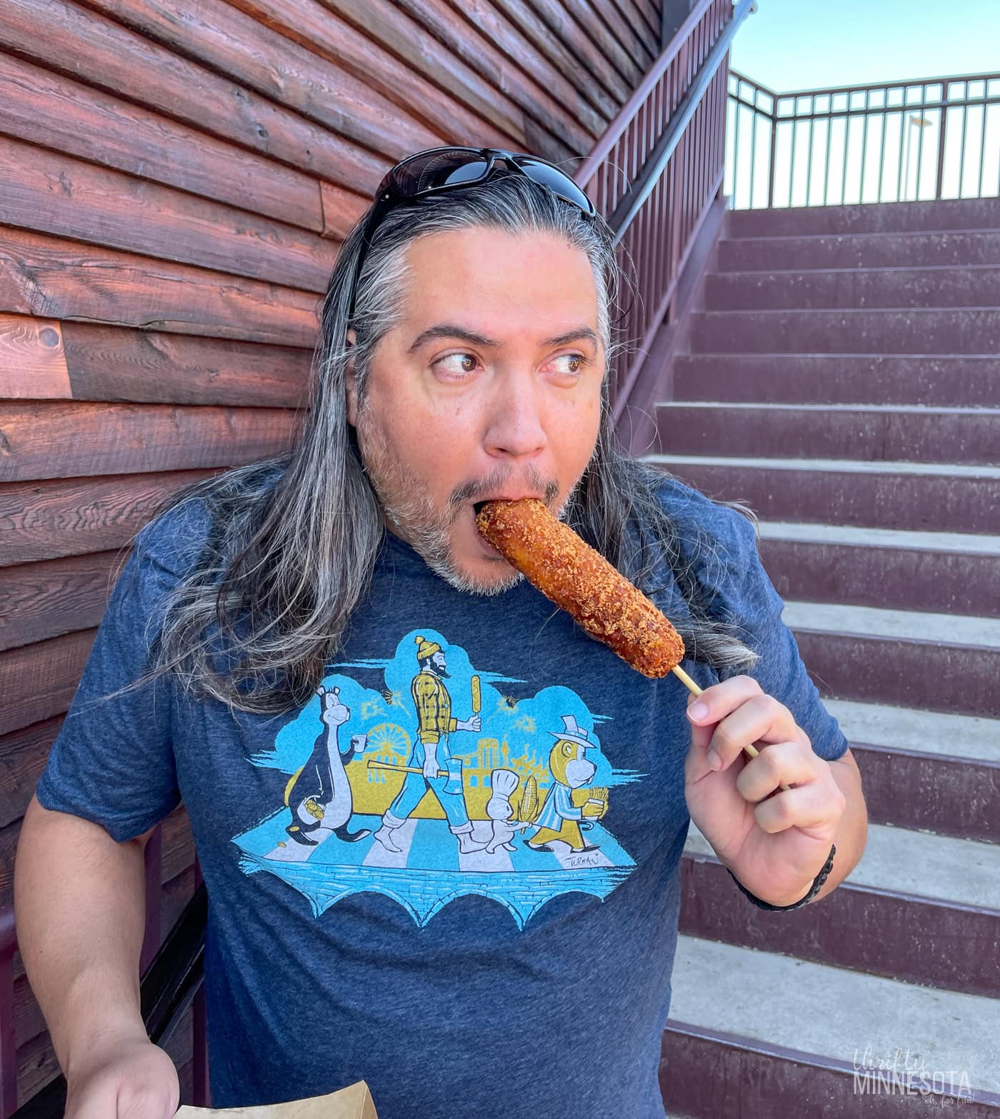 Man eating a Minnesota State Fair corn dog.