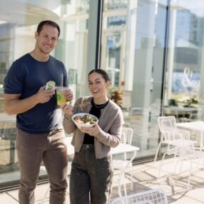 Crisp & Green Customers holding food outside restaurant.