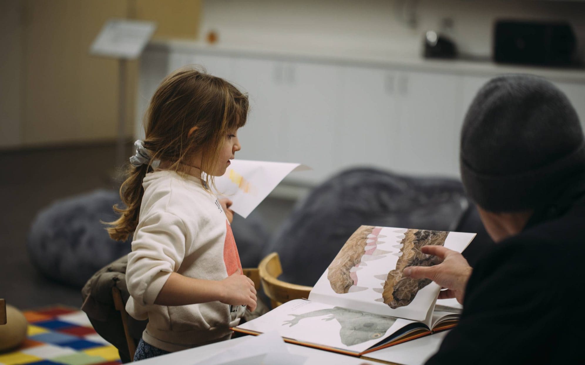 adult reading book with child at WAlker Free First Saturday storytelling event.